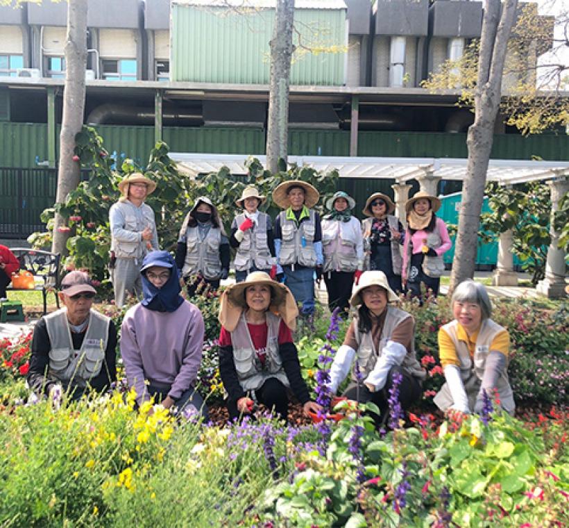 圖17志工與同仁一同養護園藝植物佈展區合影。